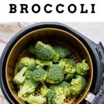 a pile of broccoli in the basket of an air fryer