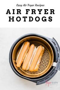 air fryer hotdogs in on buns in the basket of an air fryer
