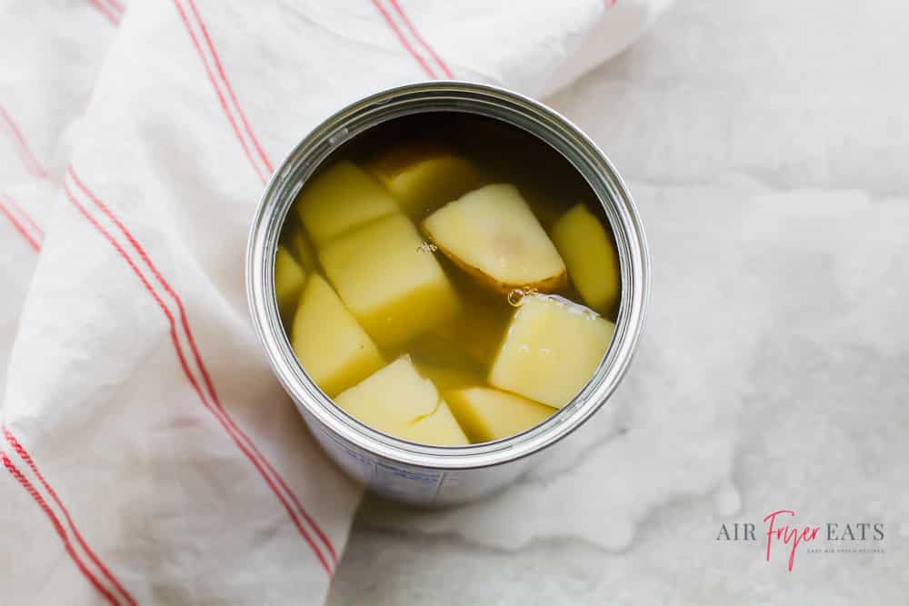 overhead shot of can of cubed potatoes with juice