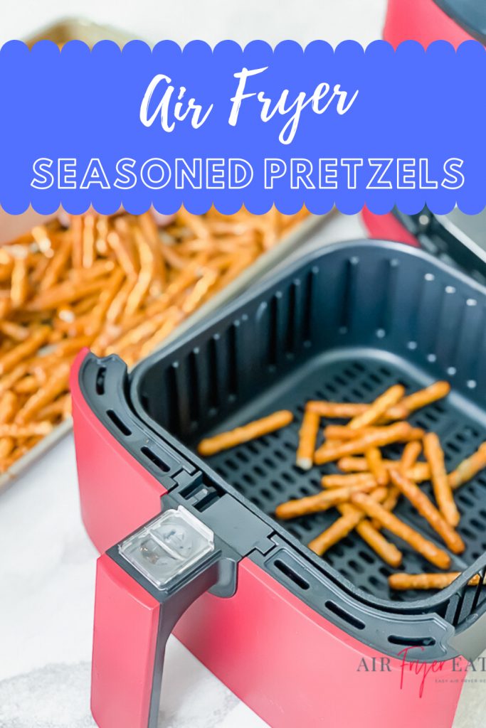 vertical image of red air fryer basket with pretzels inside and pretzels in a lipped baking sheet in the top left. Text overlay says Air Fryer Seasoned Pretzels