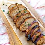 sliced turkey on a cutting board with parsley