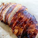 sliced seasoned turkey breast on parchment paper