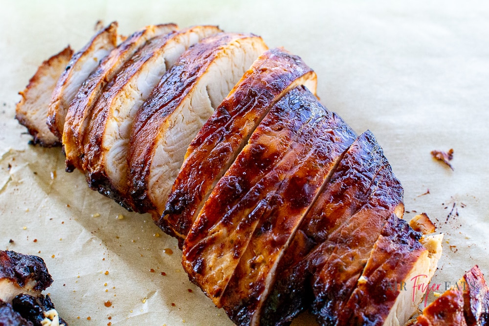 sliced seasoned turkey breast on parchment paper