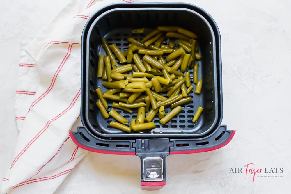 Air Fryer Green beans in a red and black air fryer basket