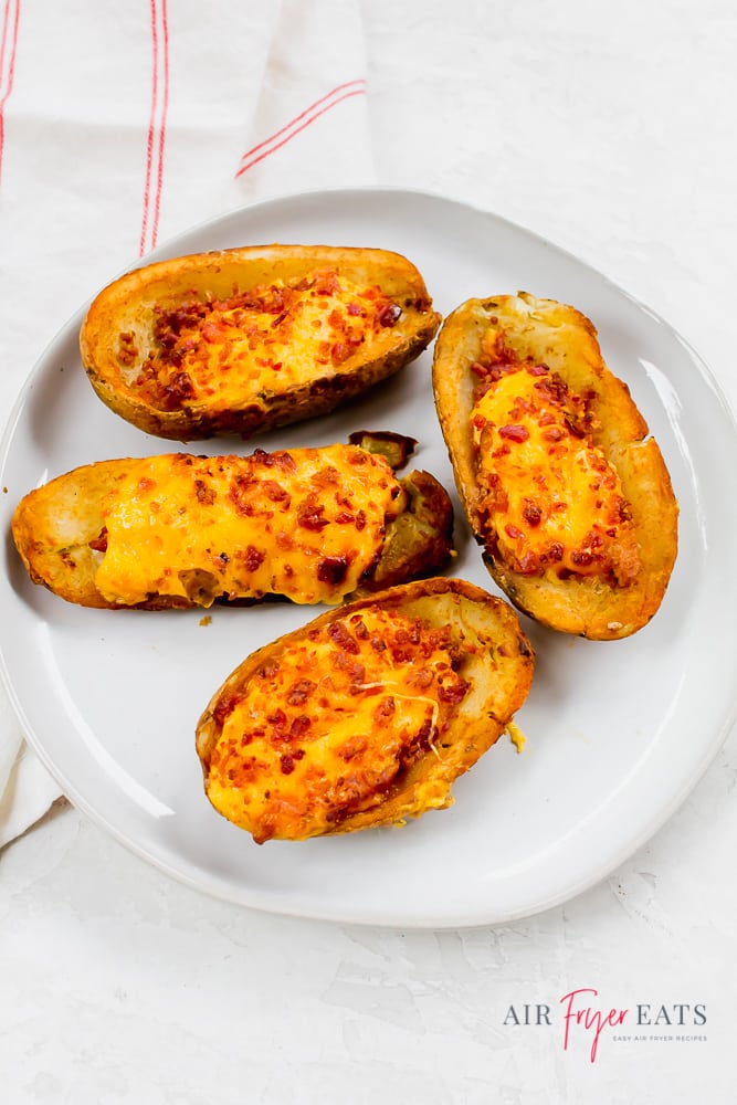 Frozen but cooked potato skins on white plate with white back ground