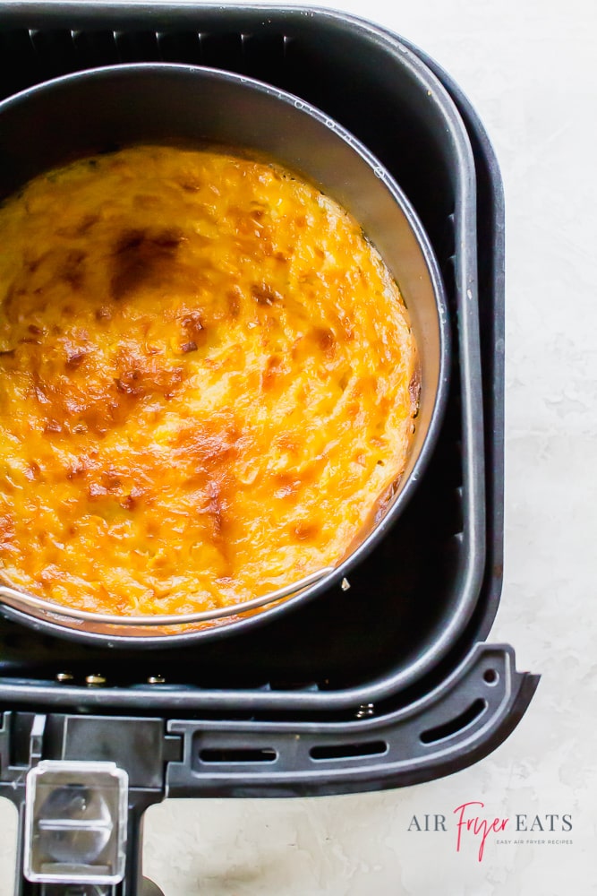 Creamed Corn Casserole in a pot inside a black air fryer basket