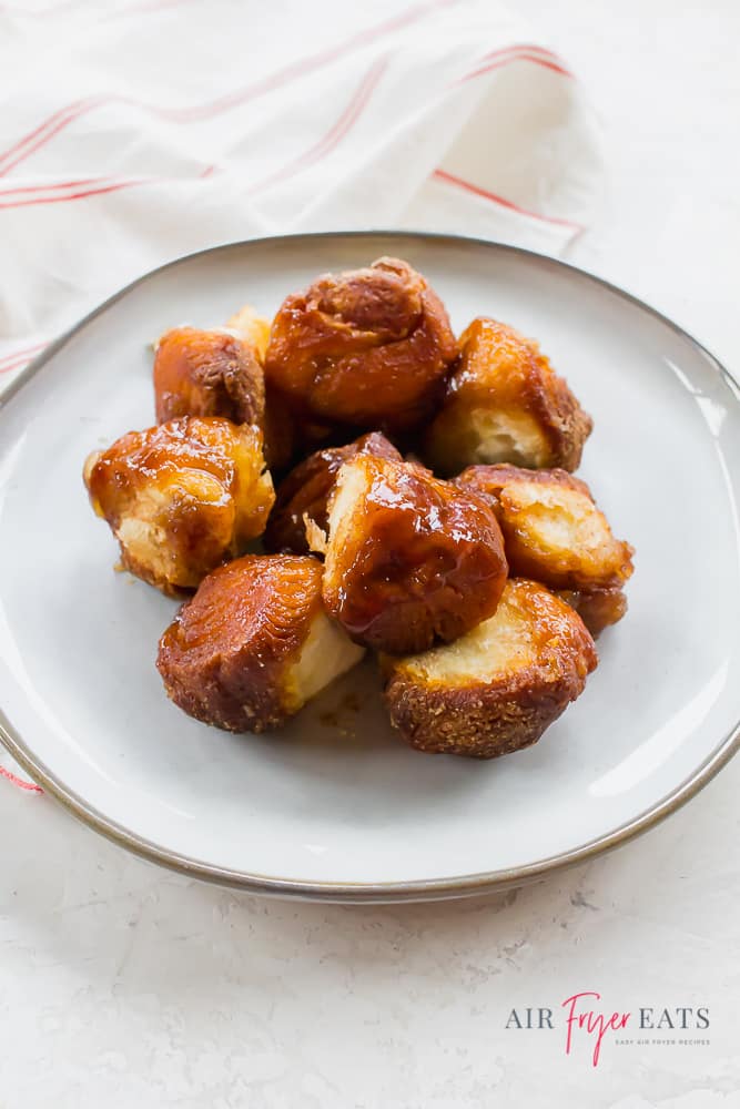 a white plate with pieces of air fryer monkey bread