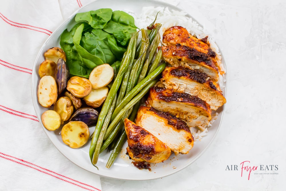 Sweet and Spicy Chicken with white rice, green beans, roasted potatoes and baby spinach