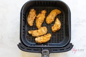 overhead shot of air fryer chicken tenders in a black air fryer basket