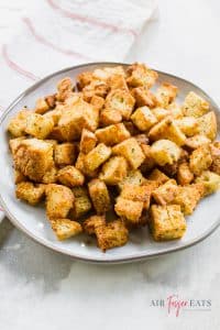 Overhead shot of a white plate covered in homemade croutons