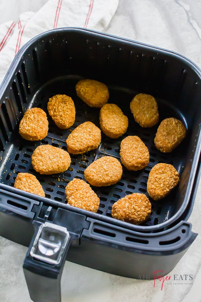 chicken nuggets in black air fryer basket