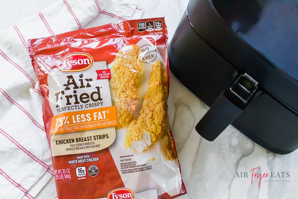 picture of Tyson Air Fried chicken breast strips bag and a black air fryer