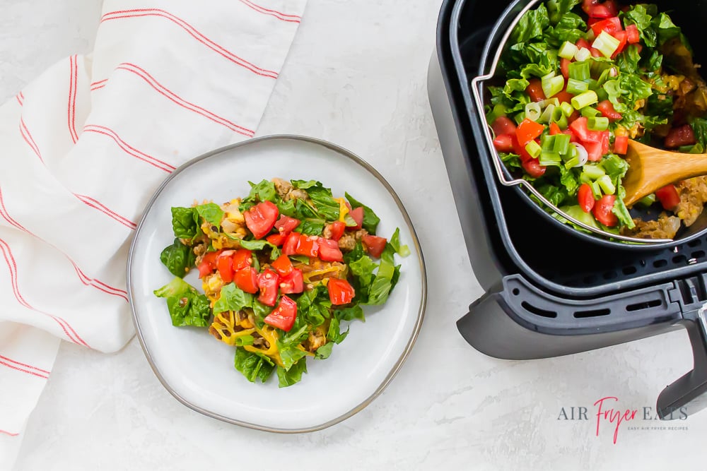 Air Fryer Taco pie on a white plate next to air fryer.