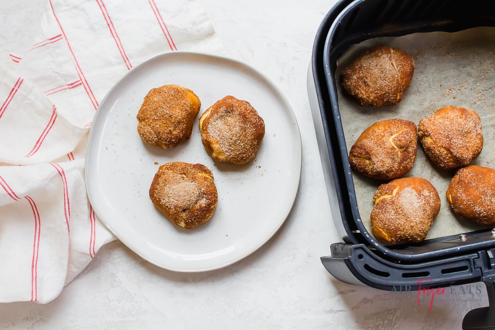 Three gingerbread bites on a round white plate next to 5 bites in an air fryer basket