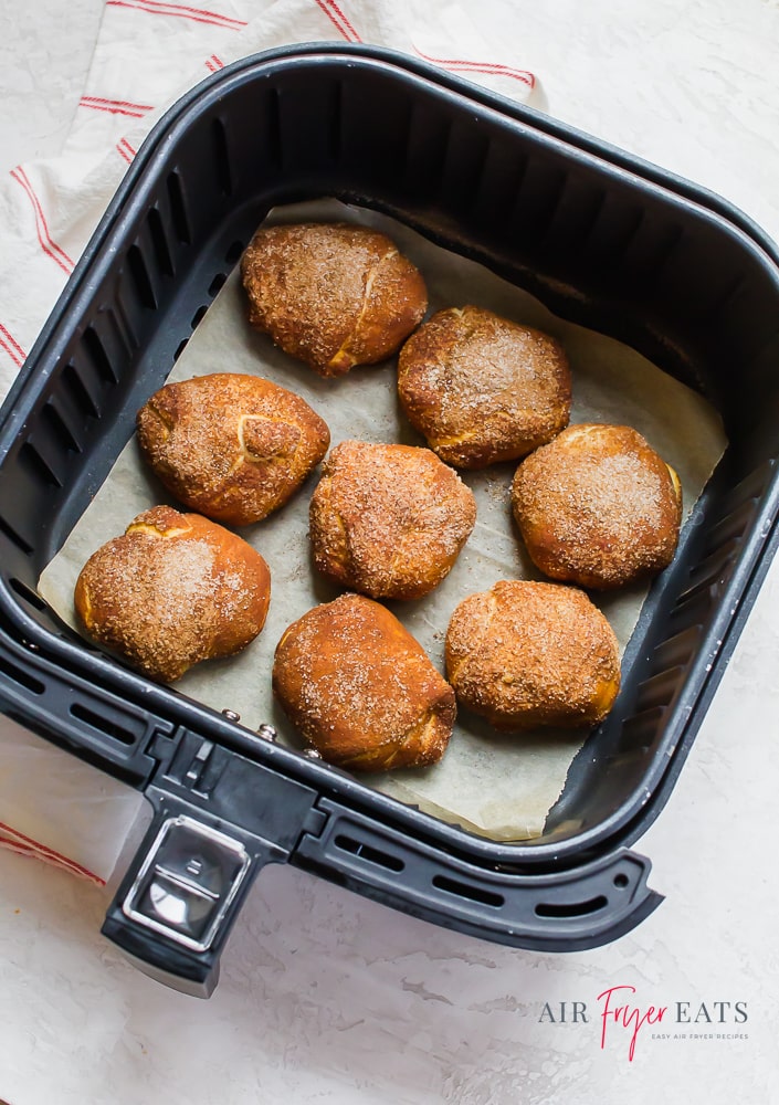 Eight fluffy gingerbread bites on parchment paper in an air fryer basket