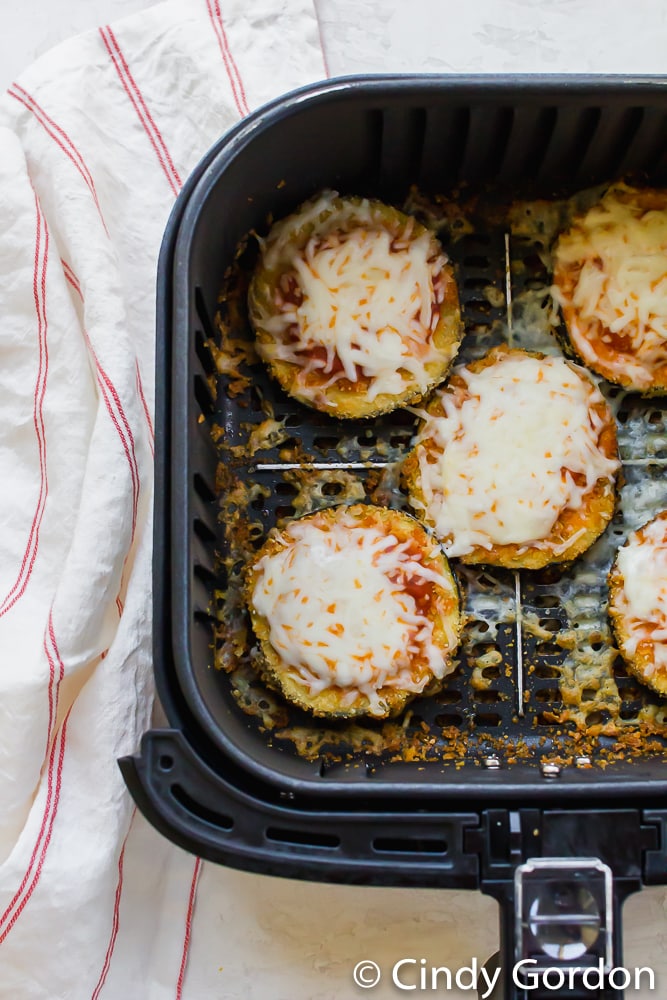 Eggplant parmesan in an air fryer basket. 