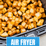 air fryer breakfast potatoes (cooked) in an air fryer basket.