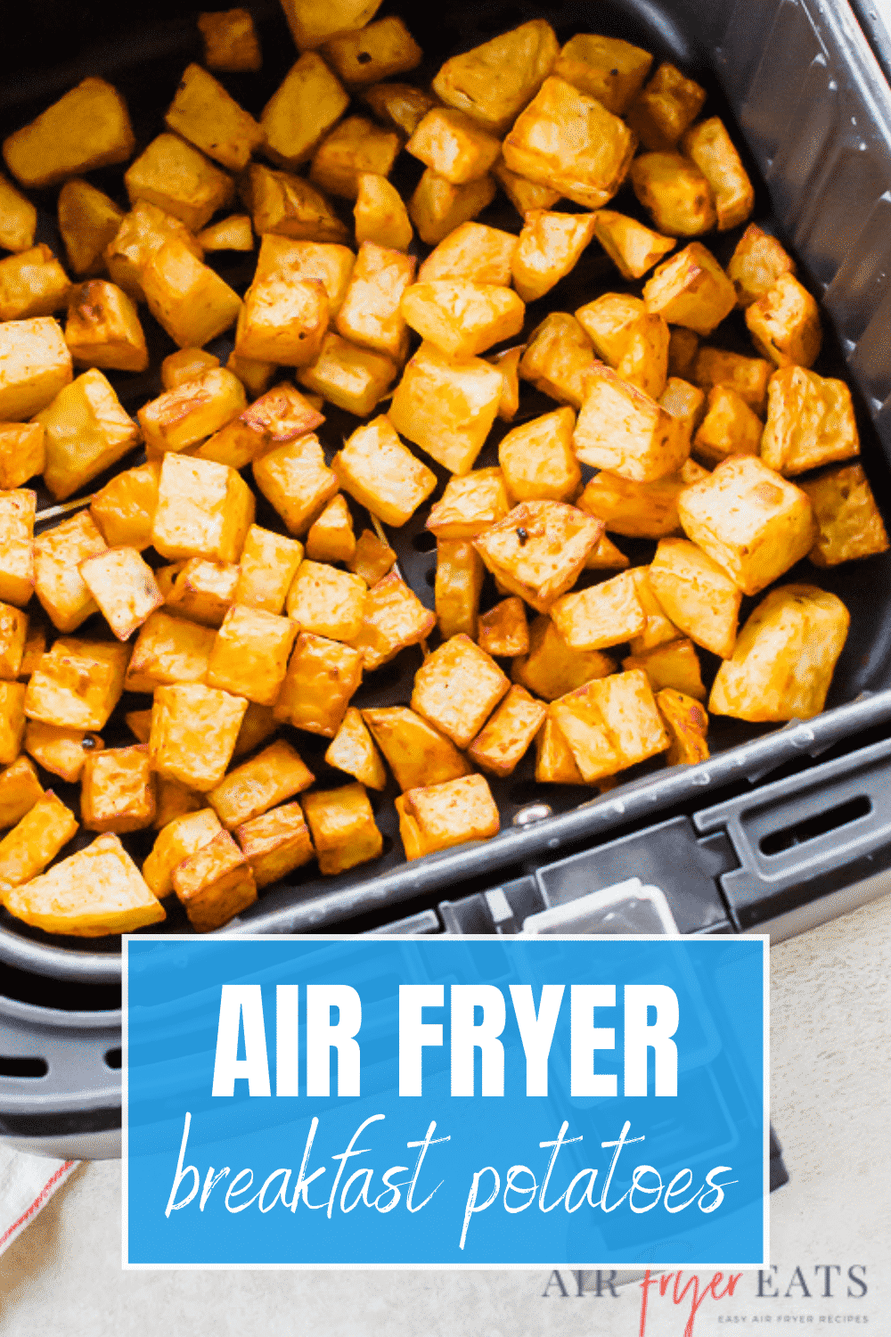 air fryer breakfast potatoes (cooked) in an air fryer basket.