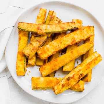 a round white plate of zucchini fries