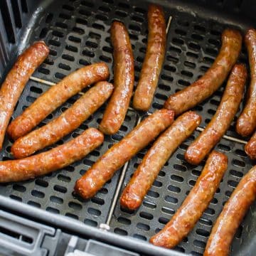 cooked sausage links in a black air fryer basket