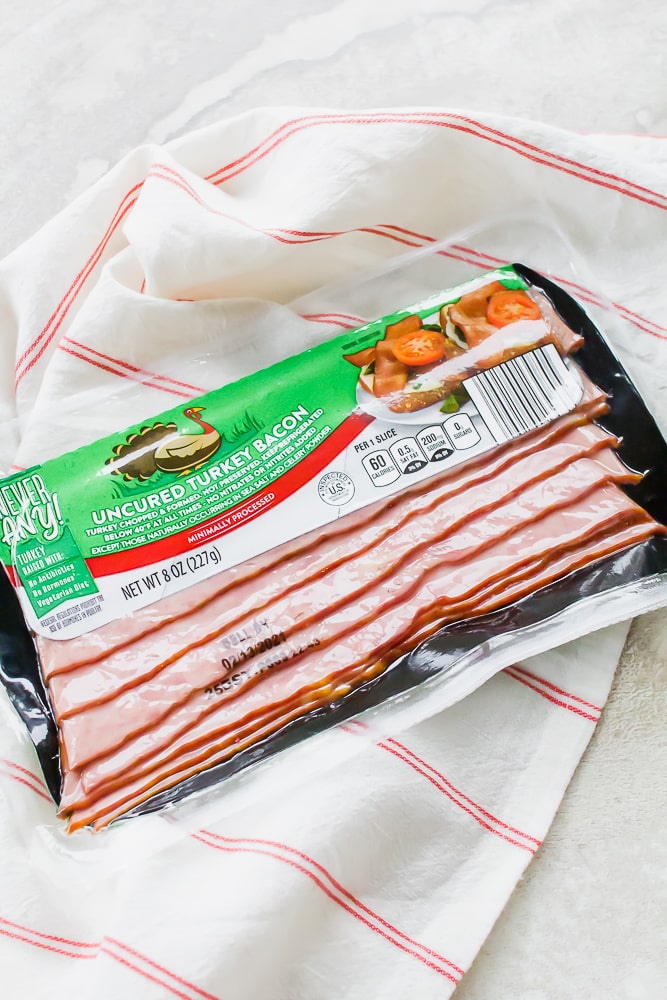 a package of turkey bacon on a kitchen towel.