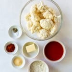 top down view of all of the ingredients needed to make air fryer buffalo cauliflower, each in separate bowls.