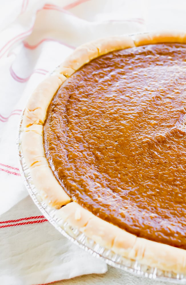 an image of half of a pumpkin pie on top of a red and white striped towel