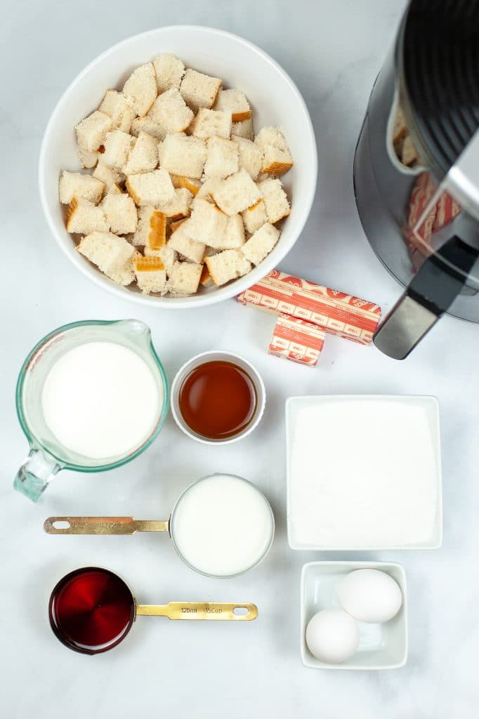 ingredients for air fryer bread pudding on a white countertop