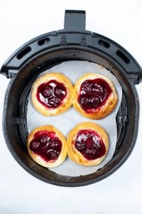 four cooked danish in an air fryer basket