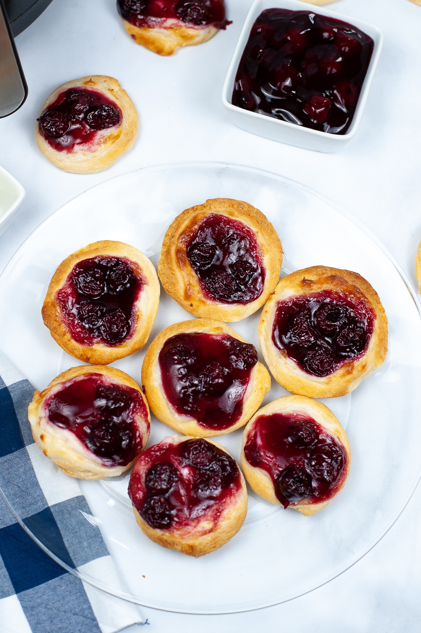 a plate of seven cherry danishes.