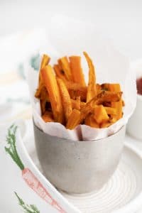a silver cup holding carrot matchstick fries