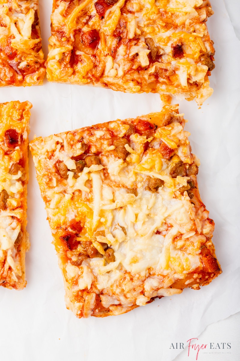 Close-up shot of a Totino's pizza cut into squares