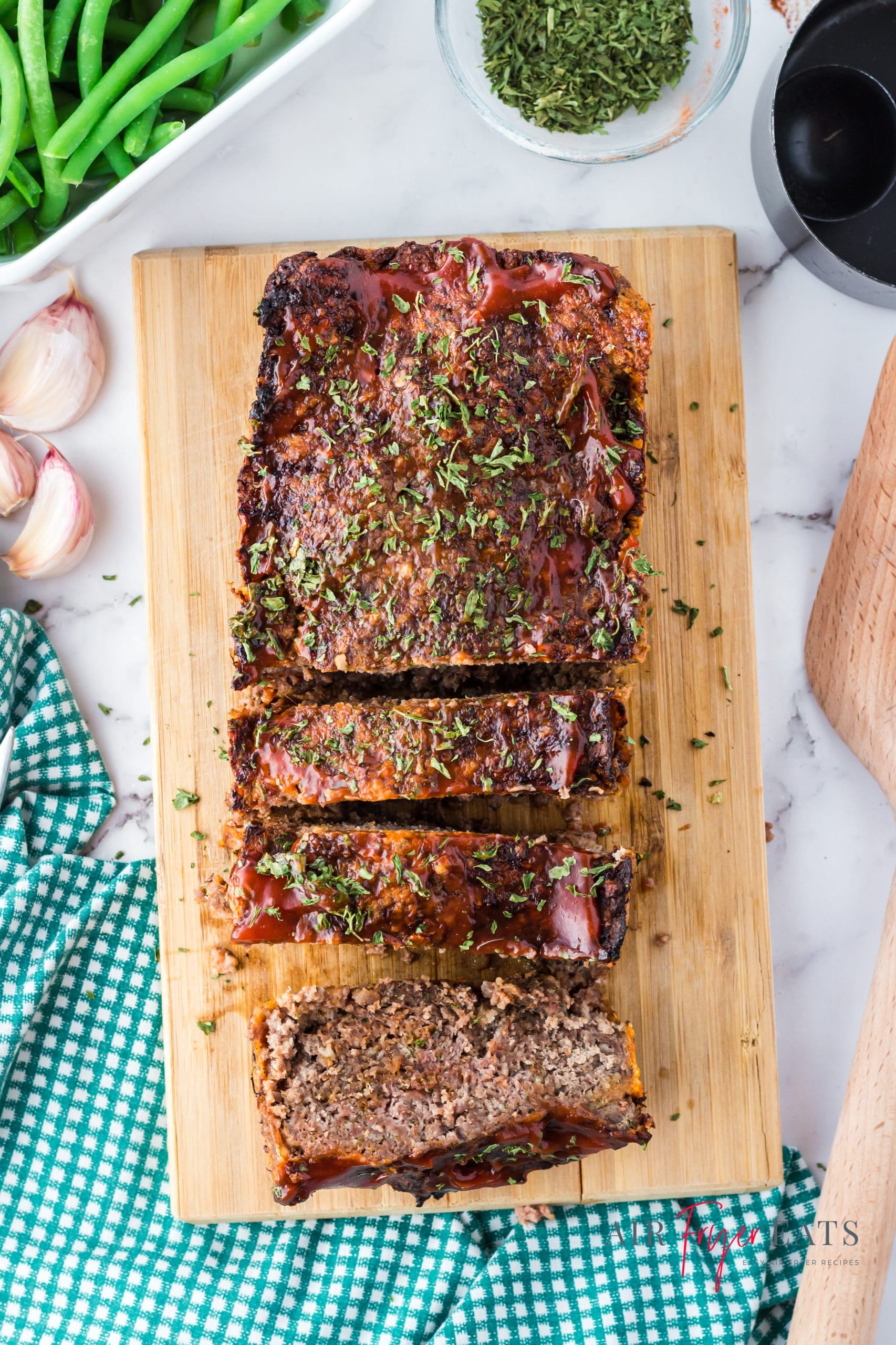 a meatloaf on a wooden cutting board, sliced.