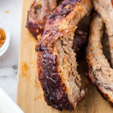 sliced ribs on a wooden cutting board