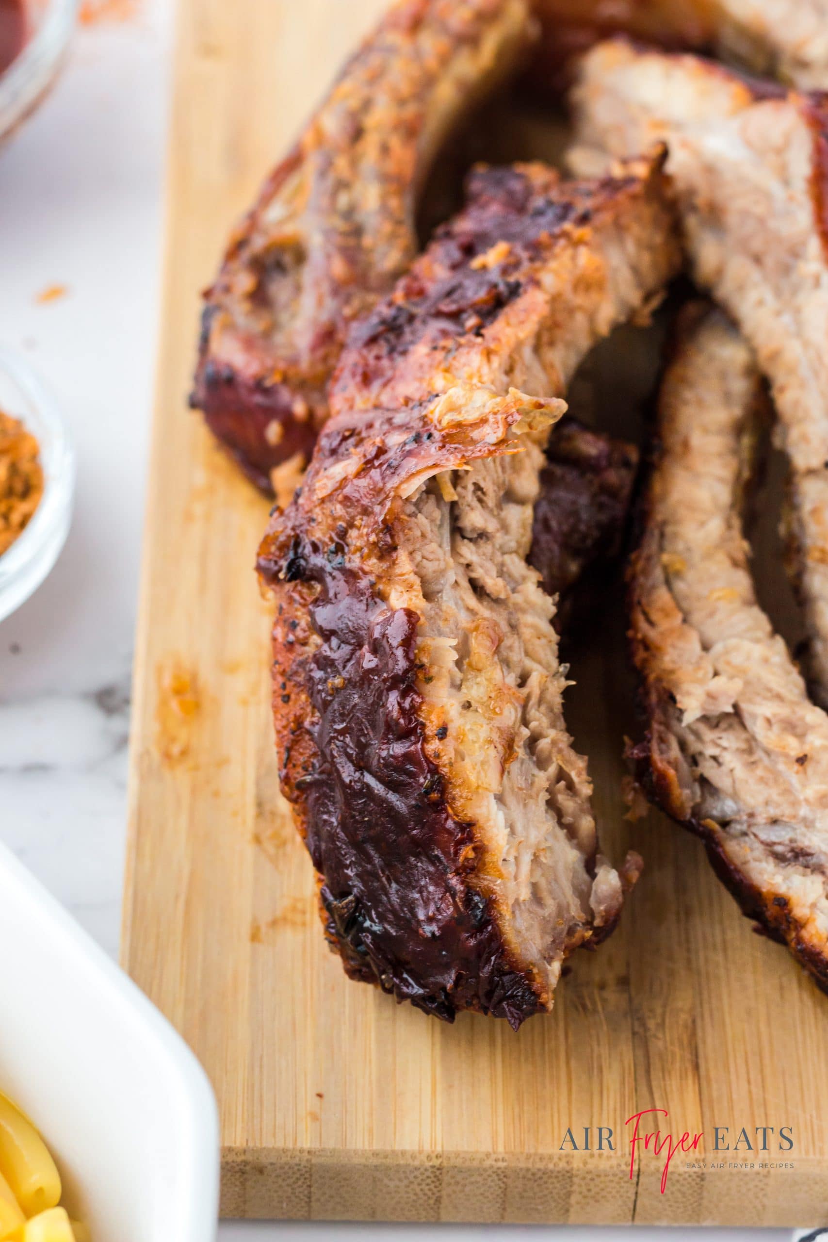 sliced ribs on a wooden cutting board