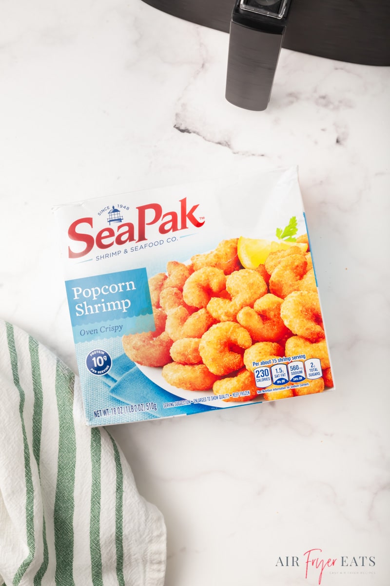 a box of seapak frozen popcorn shrimp next to a cosori air fryer