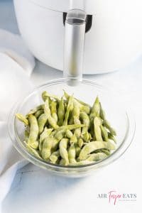 Frozen edamame in a large glass bowl