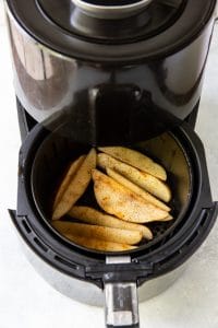 black air fryer basket with air fried potato wedges