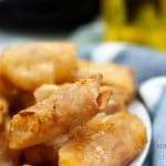 A close up image of cooked air fryer pizza egg rolls