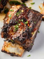 a trimmed beef short rib with sauce, viewed close up