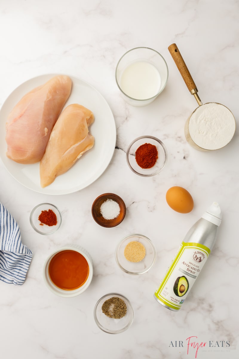 The ingredients for air fryer boneless wings with fresh chicken, seasonings and flour
