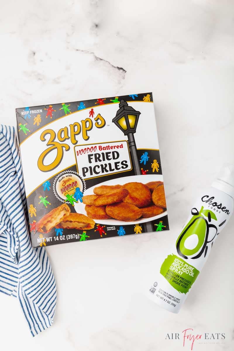 a box of zappos fried pickles and a bottle of avocado oil spray on a marble counter