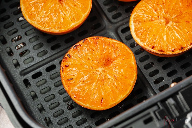 closeup of oranges in a square cosori air fryer basket