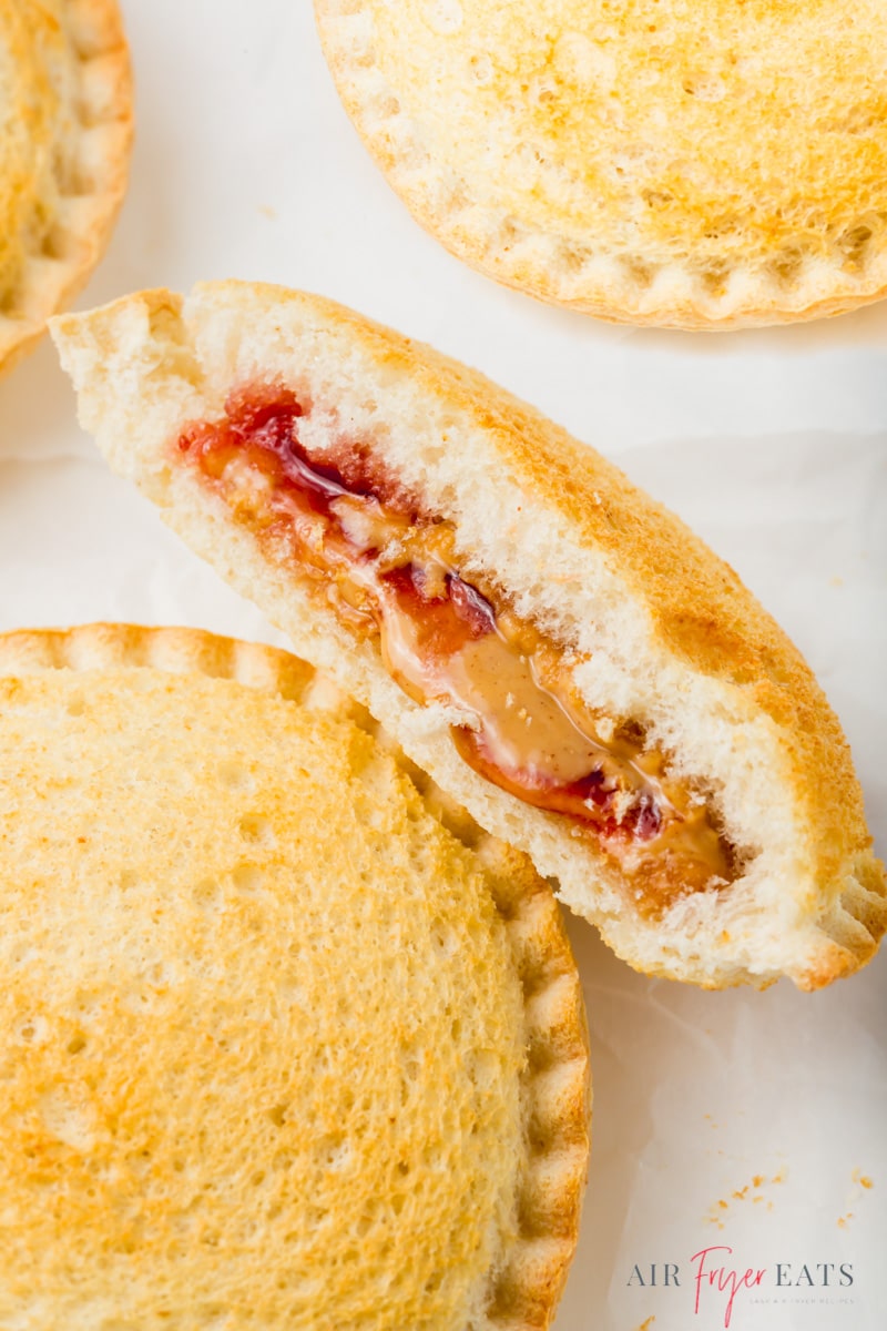 a PBJ uncrustable, cut in half to show that it's been air fried and is hot and melty