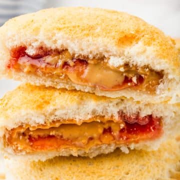 an uncrustable sandwich that has been air fried, cut in half to show the peanut butter and jelly inside