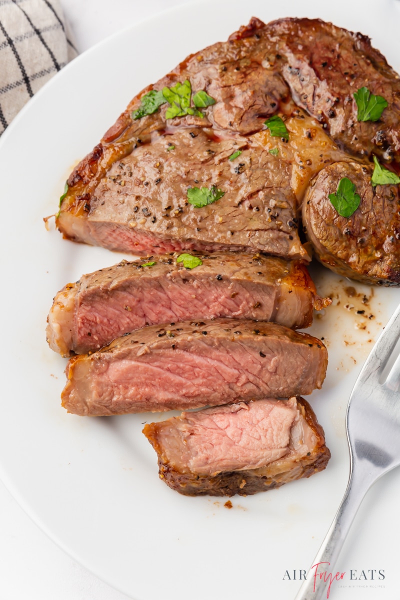 a cooked ribeye steak, sliced. 