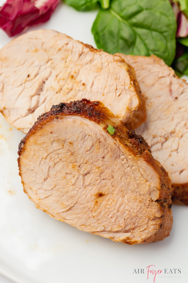Closeup view of slices of pork loin cooked in an air fryer.