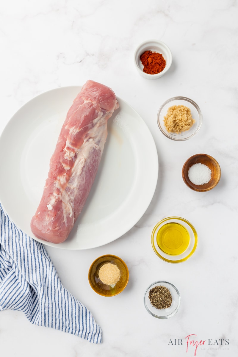 The ingredients needed to make pork loin in the air fryer, including seasonings and oil. 