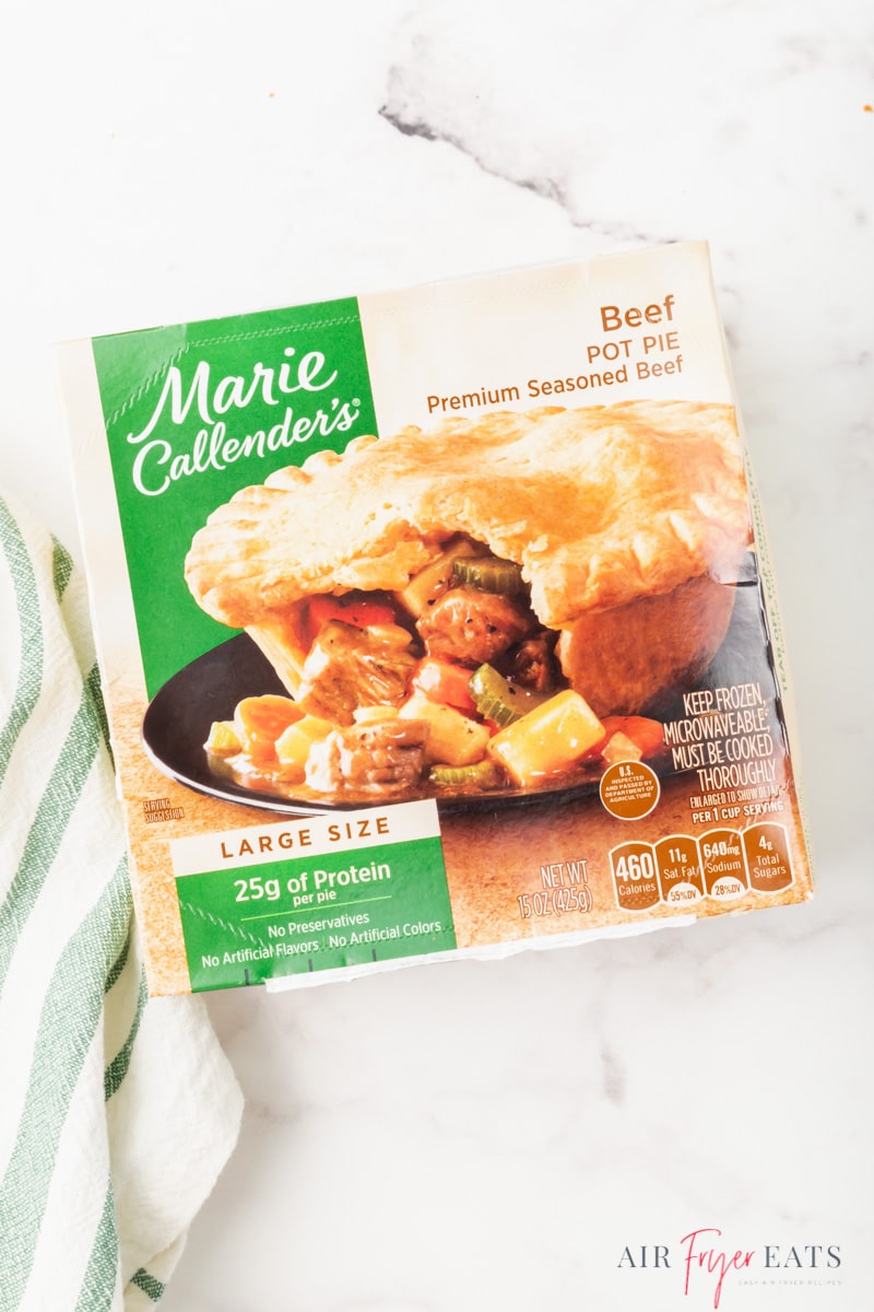 a marie callender's pot pie in the box, on the counter.