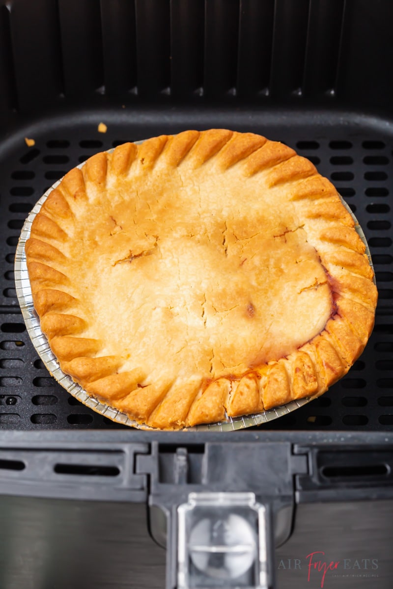 closeup view of a cooked pot pie in a cosori air fryer basket
